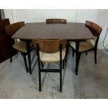 A Mid Century teak dining table and four chairs and centre leaf