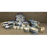 A selection of blue and white ceramics to include tea pots, dinner plates and a miniature tea