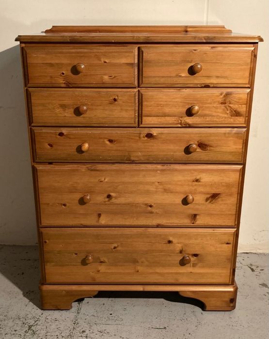 A Ducal four over three pine chest of drawers (H115cm W86cm D46cm)