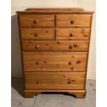 A Ducal four over three pine chest of drawers (H115cm W86cm D46cm)