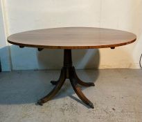 A mahogany centre table on splayed legs with castors and lion paw feet (H72cm Dia131cm)