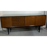 A vintage Mid Century side board with cupboards and drawers