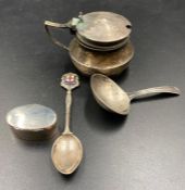 Four small silver items to include a caddy spoon, mustard pot, teaspoon and a pill box.