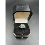 An aquamarine and diamond ring, marked 375 and size Q.