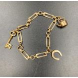 A 9ct gold charm bracelet with three charms (Approximate Total weight 8.1g)