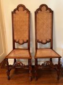A pair of cane backed and seated hall chairs in a Carolean style