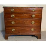 An antique mahogany cutlery chest of drawers with drop down handles and glass top