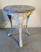 A cast iron white painted garden table with Britannia theme casting on lions paw feet (H76cm