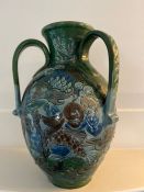 A CH Brannam art pottery three handled vase. An earthenware vase decorated in relief design. the