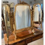 A gilt painted triptych mirror with mirrored sides