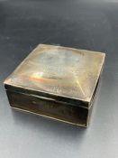 A silver cigarette box, hallmarked for Chester and carrying a military 1918 dedication