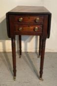 A mahogany drop leaf side table on castors with two drawers to side (H71cm W50cm D35cm)