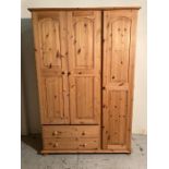 A three door pine wardrobe with two door below (H181cm W122cm D53cm)