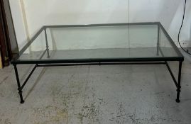 A metal framed glass top coffee table (47cm x 90cm x 150cm)