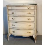 A white painted Louis style dressing table with a five drawer matching set of drawers