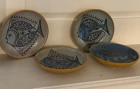 Four Studio pottery plates with fish design signed to base