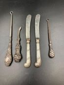 A small selection of silver handled items to include two knives and part of a vanity set.