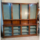 A Mid Century eight cupboard display unit (H225cm W240cm D31cm)