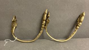A pair of gilt bronze curtain tie backs in the rococo style