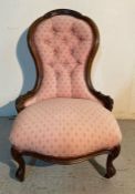 An antique spoon back nursing chair with pink upholstery