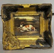 A picture of two dogs in a woodland scene in a heavy gilt frame AF (24cm x 19cm)