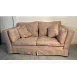 A Duresta two seater sofa, upholstered with a pink and gold floral pattern