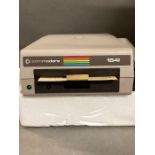 A Commodore 1541 disk drive with a matrix printer, boxed