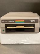A Commodore 1541 disk drive with a matrix printer, boxed