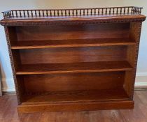 A carved open bookcase with galleried top (133cm x 24cm x 110cm)
