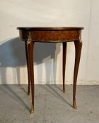 A continental parquetry occasional table on cabriole legs with gilt banding and Floyd motifs (