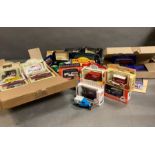 A box containing a selection of diecast vehicles.