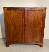 A mahogany two door, three shelf cabinet