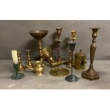 A selection of brass and copper candle sticks and other brass items