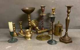 A selection of brass and copper candle sticks and other brass items