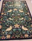 A Liberty carpet with strawberry thief motif by William Morris
