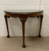 A demi lune Chippendale style walnut table on cabriole legs