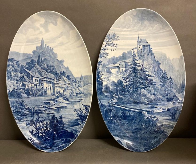 A pair of rare oval blue and white, mountain scenes wall plaques
