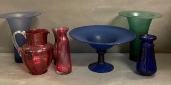 A selection of coloured glassware to include a jug, five vases and a fruit bowl