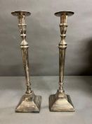 A pair of white metal candle sticks 40.5cm H