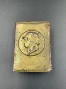 A WWII German military themed matchbox holder in brass.