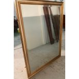 A wooden silver and gold framed wall mirror (142cm x 155cm)