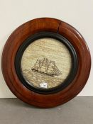 A mahogany circular framed needlework of a ship (Dia40cm) AF