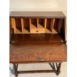 An oak bureau with fall front opening to drawers (H100cm W74cm D39cm)