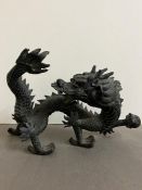 A cast metal dragon with fire ball (H27cm W40cm)