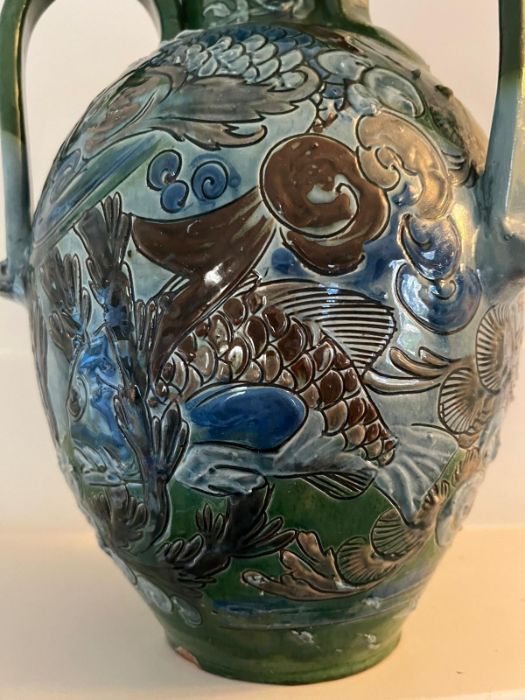 A CH Brannam art pottery three handled vase. An earthenware vase decorated in relief design. the - Image 5 of 7