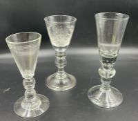 Three tall goblets all with turned stems and one engraved of gentleman fishing (H21cm)
