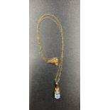 A 9ct gold blue stone pendant and chain.