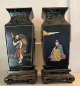 A pair of Chinese ebonised vases, pearlized tops depicting the eight fairies festival