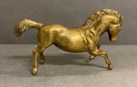 A vintage brass horse cantering