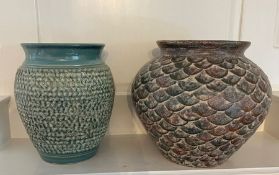 Two vases with a hammered design and shell